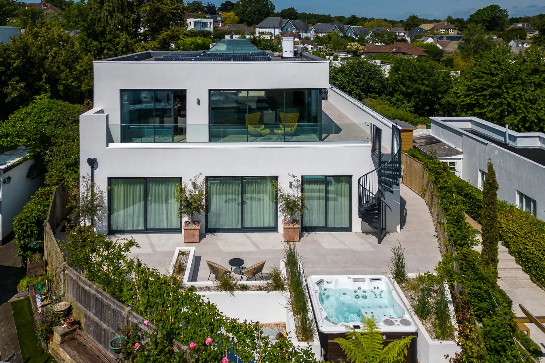 Skippers Retreat from the air — a white Mediterranean house with a roof terrace and a hot tub set into the landscaped courtyard below